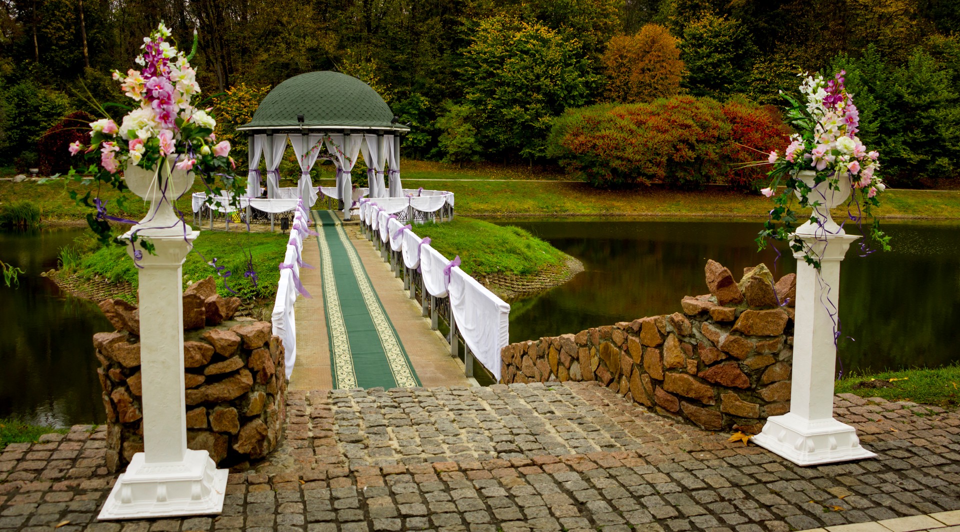 Gazebo in the park surrounded by fall foliage at autumn